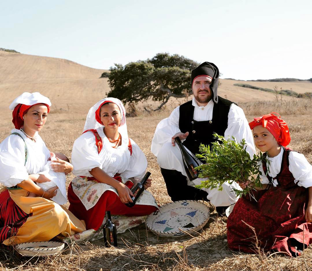 Women, men and boys in traditional Sardinian dress